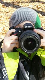 Close-up of photographer holding camera