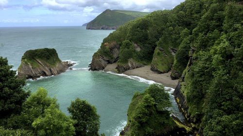 Scenic view of sea and mountains against sky