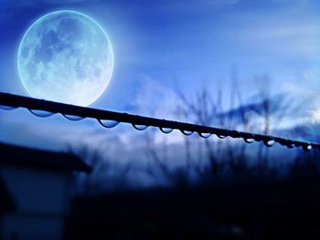 Low angle view of silhouette moon against sky at night