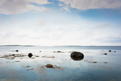 Rocks on beach against sky