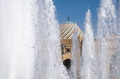 Water splashing in fountain against building