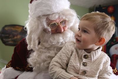 Cute boy with santa clause at home