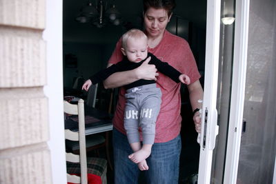 Happy mother with baby standing at home