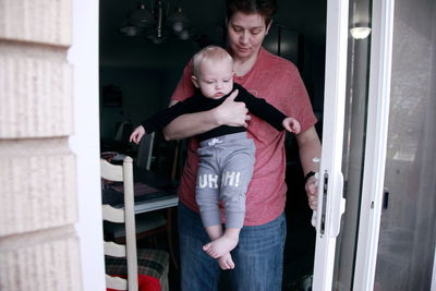 Happy mother with baby standing at home
