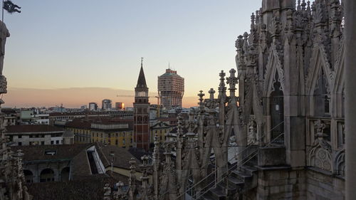 Panoramic view of buildings against sky at sunset