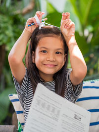 Portrait of a smiling girl holding camera