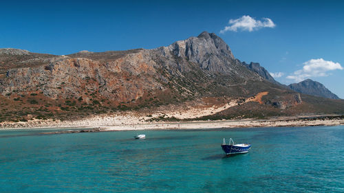 Boat sailing on sea against sky