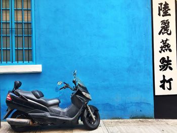 Motorcycle against blue wall