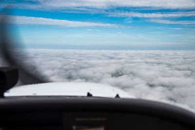 Scenic view of airplane wing against cloudy sky