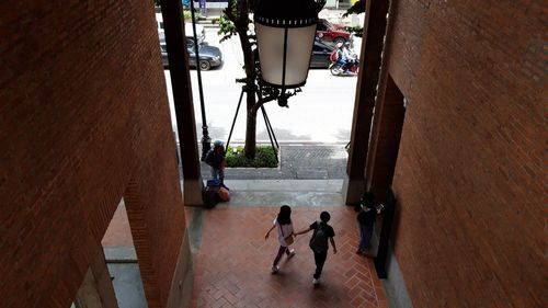 High angle view of people walking on floor in city