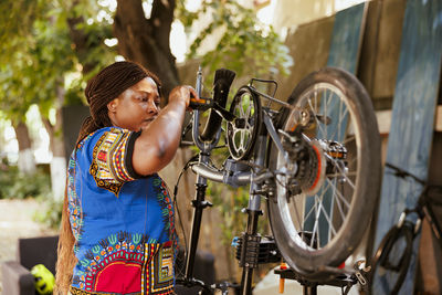 Side view of woman riding bicycle