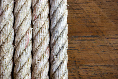 Close-up of rope against wood