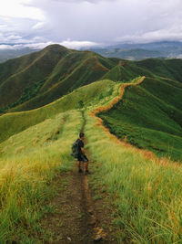 High angle view of man looking at view while standing on footpath