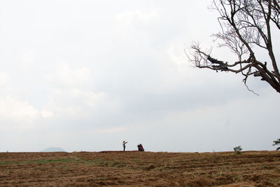 People on field against sky