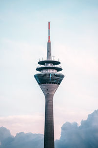 Low angle view of tower and building against sky