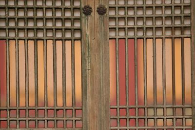 Close-up of fence against building