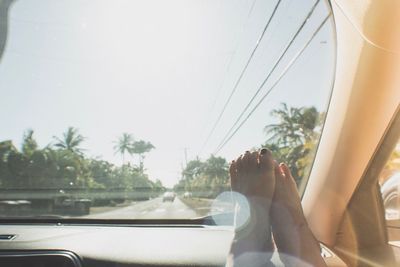 Low section of man relaxing in car