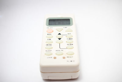 Close-up of telephone over white background