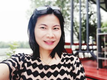 Close-up portrait of smiling mature woman outdoors