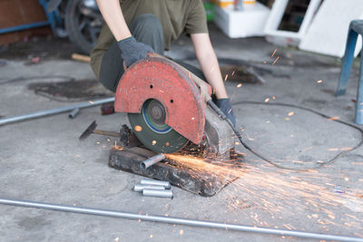 Low angle view of man working on metal