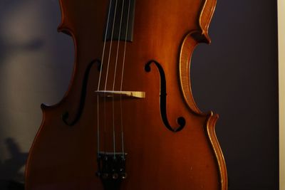 Close-up of guitar against colored background