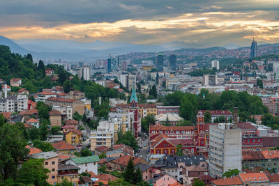 High angle shot of townscape against sky at sunset