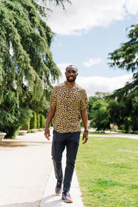 Positive afro american stylish man in european city