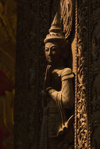 Statue of buddha against building