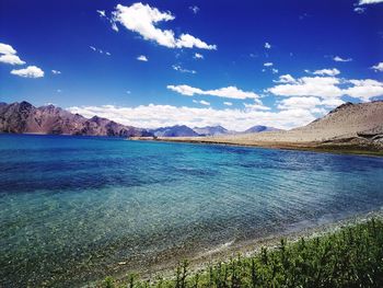 Scenic view of mountains against blue sky