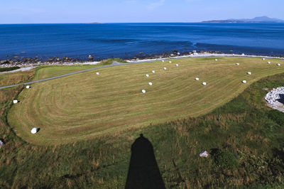 High angle view of land and sea against sky