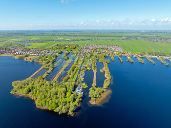 High angle view of city by sea against sky