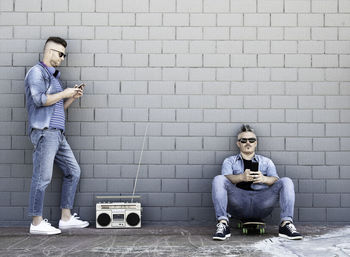 Full length of men in front of wall