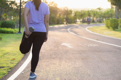 Full length of man skateboarding on footpath