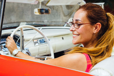 Close-up of young woman driving