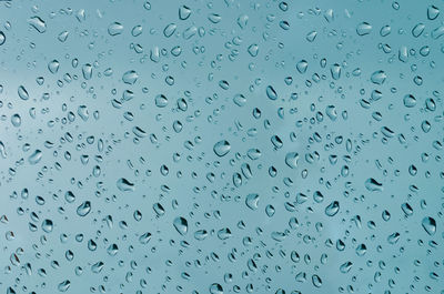 Full frame shot of raindrops on window