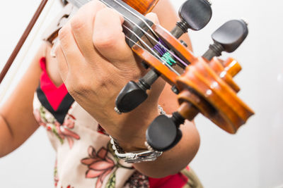 Midsection of young woman playing violin