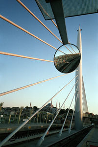 Low angle view of bridge and buildings against sky