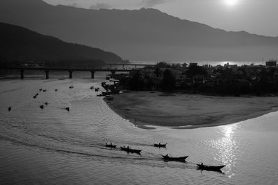 Silhouette boats in calm sea