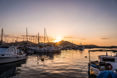 Sailboats in marina at sunset