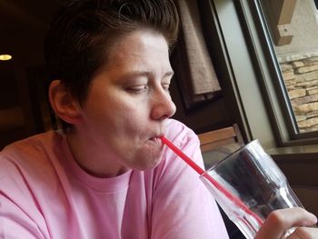 Close-up of young woman drinking glass