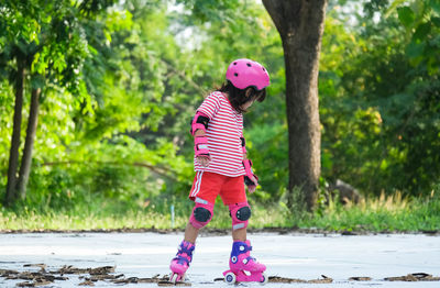 Side view of boy running on field