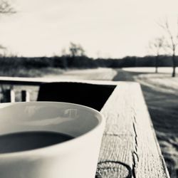 Close-up of coffee cup on table against sky