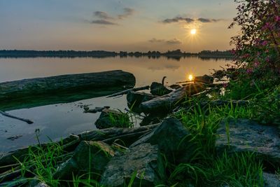 Scenic view of lake against sky during sunset