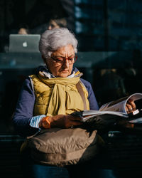 Woman sitting on seat at home