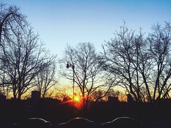 Silhouette bare trees against sky during sunset