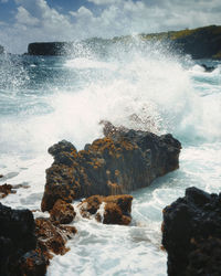 Waves splashing on rocks at shore