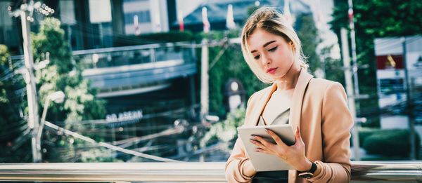 Young woman using smart phone outdoors