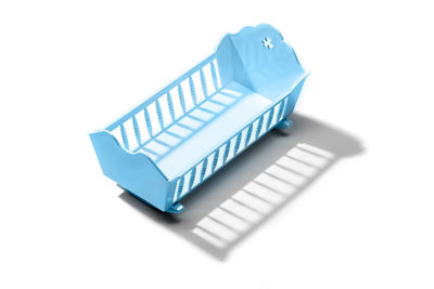 Blue baby crib isolated on white background. male birthrates concept