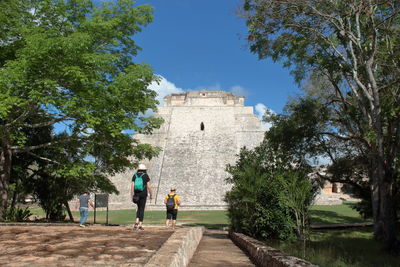 People walking in park against sky