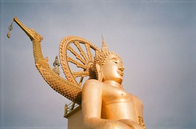Low angle view of statue against sky